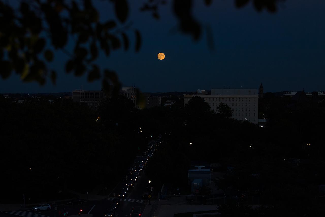 The nearly full Moon is seen as it rises from The Observatory at America’s Square in Washington, Tuesday, Oct. 19, 2021. Photo Credit: (NASA/Aubrey Gemignani)