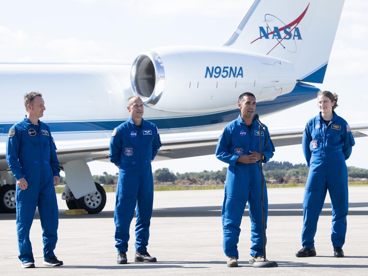 NASA astronaut Raja Chari, second from right, speaks to members of the media after arriving from Houston at the Launch and Landing Facility at NASA’s Kennedy Space Center with fellow NASA astronauts Tom Marshburn, second from left and Kayla Barron, right, and ESA (European Space Agency) astronaut Matthias Maurer, left, ahead of SpaceX’s Crew-3 mission, Tuesday, Oct. 26, 2021, in Florida. NASA’s SpaceX Crew-3 mission is the third crew rotation mission of the SpaceX Crew Dragon spacecraft and Falcon 9 rocket to the International Space Station as part of the agency’s Commercial Crew Program. Chari, Marshburn, Barron, Maurer are scheduled to launch at Oct. 31 at 2:21 a.m. ET, from Launch Complex 39A at the Kennedy Space Center. Photo Credit: (NASA/Joel Kowsky)
