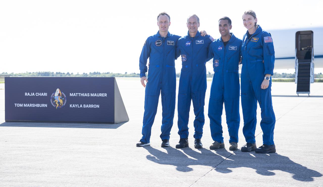 ESA (European Space Agency) astronaut Matthias Maurer, left, and NASA astronauts Tom Marshburn, second from left, Raja Chari, second from right, and Kayla Barron, right, pose for a picture after answering questions from members of the media following their arrival at the Launch and Landing Facility at NASA’s Kennedy Space Center ahead of SpaceX’s Crew-3 mission, Tuesday, Oct. 26, 2021, in Florida. NASA’s SpaceX Crew-3 mission is the third crew rotation mission of the SpaceX Crew Dragon spacecraft and Falcon 9 rocket to the International Space Station as part of the agency’s Commercial Crew Program. Chari, Marshburn, Barron, Maurer are scheduled to launch at Oct. 31 at 2:21 a.m. ET, from Launch Complex 39A at the Kennedy Space Center. Photo Credit: (NASA/Joel Kowsky)