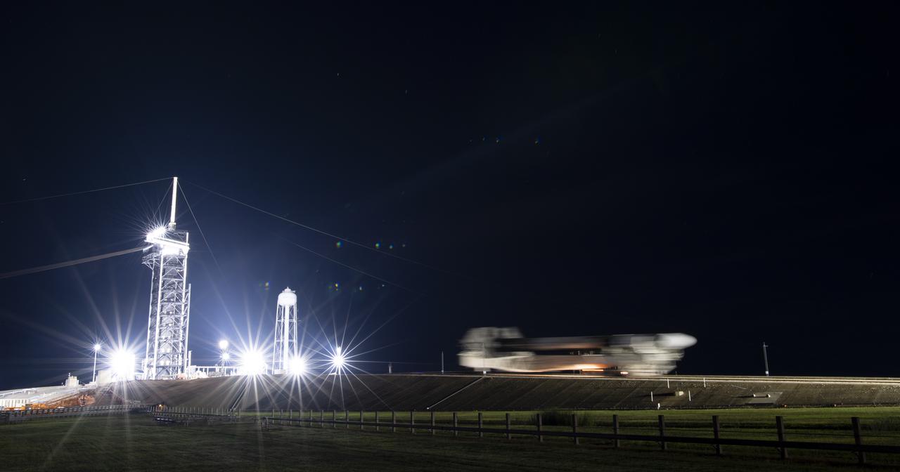 In this 90-second exposure, a SpaceX Falcon 9 rocket with the company's Crew Dragon spacecraft onboard is seen as it is rolled out to the launch pad at Launch Complex 39A as preparations continue for the Crew-3 mission, Wednesday, Oct. 27, 2021, at NASA’s Kennedy Space Center in Florida. NASA’s SpaceX Crew-3 mission is the third crew rotation mission of the SpaceX Crew Dragon spacecraft and Falcon 9 rocket to the International Space Station as part of the agency’s Commercial Crew Program. NASA astronauts Raja Chari, Tom Marshburn, Kayla Barron, and ESA (European Space Agency) astronaut Matthias Maurer are scheduled to launch on Oct. 31 at 2:21 a.m. ET, from Launch Complex 39A at the Kennedy Space Center. Photo Credit: (NASA/Joel Kowsky)
