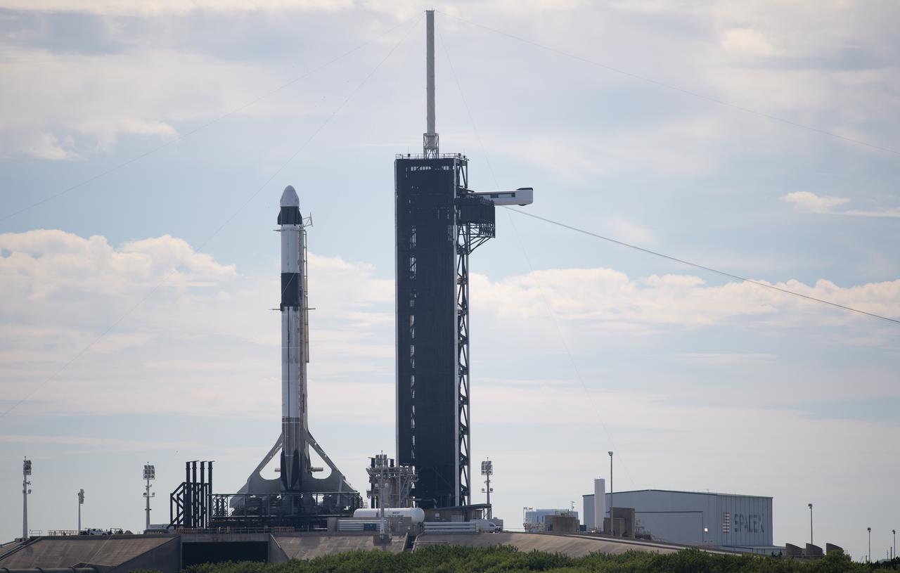 A SpaceX Falcon 9 rocket with the company's Crew Dragon spacecraft onboard is seen after being raised into a vertical position on the launch pad at Launch Complex 39A as preparations continue for the Crew-3 mission, Wednesday, Oct. 27, 2021, at NASA’s Kennedy Space Center in Florida. NASA’s SpaceX Crew-3 mission is the third crew rotation mission of the SpaceX Crew Dragon spacecraft and Falcon 9 rocket to the International Space Station as part of the agency’s Commercial Crew Program. NASA astronauts Raja Chari, Tom Marshburn, Kayla Barron, and ESA (European Space Agency) astronaut Matthias Maurer are scheduled to launch on Oct. 31 at 2:21 a.m. ET, from Launch Complex 39A at the Kennedy Space Center. Photo Credit: (NASA/Joel Kowsky)