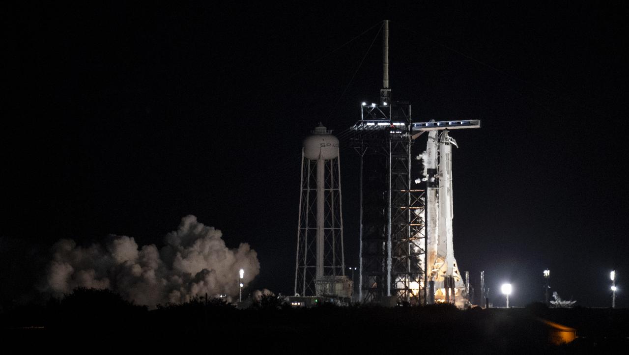 A SpaceX Falcon 9 rocket with the company's Crew Dragon spacecraft onboard is seen on the launch pad at Launch Complex 39A during a brief static fire test ahead of NASA’s SpaceX Crew-3 mission, Thursday, Oct. 28, 2021, at NASA’s Kennedy Space Center in Florida. NASA’s SpaceX Crew-3 mission is the third crew rotation mission of the SpaceX Crew Dragon spacecraft and Falcon 9 rocket to the International Space Station as part of the agency’s Commercial Crew Program. NASA astronauts Raja Chari, Tom Marshburn, Kayla Barron, and ESA (European Space Agency) astronaut Matthias Maurer are scheduled to launch on Oct. 31 at 2:21 a.m. ET, from Launch Complex 39A at the Kennedy Space Center. Photo Credit: (NASA/Joel Kowsky)