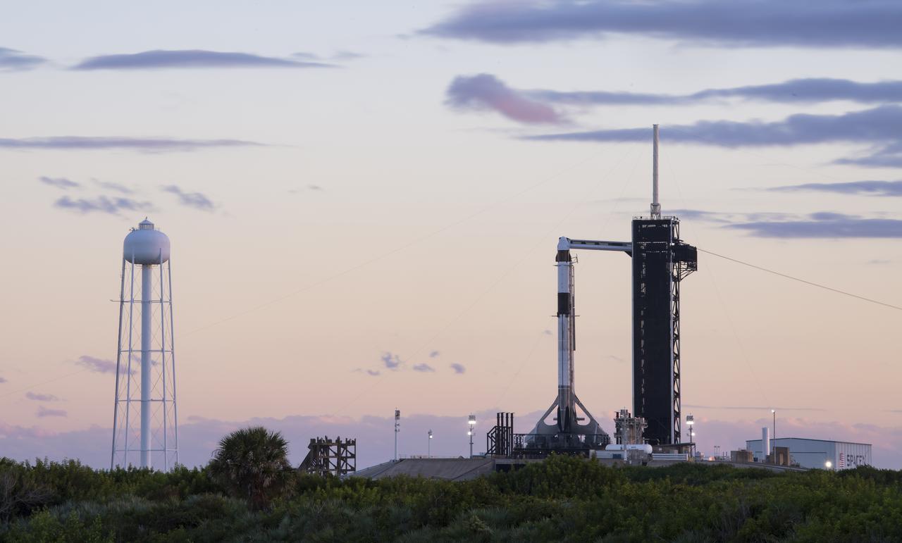 A SpaceX Falcon 9 rocket with the company's Crew Dragon spacecraft onboard is seen at sunset on the launch pad at Launch Complex 39A as preparations continue for the Crew-3 mission, Saturday, Oct. 30, 2021, at NASA’s Kennedy Space Center in Florida. NASA’s SpaceX Crew-3 mission is the third crew rotation mission of the SpaceX Crew Dragon spacecraft and Falcon 9 rocket to the International Space Station as part of the agency’s Commercial Crew Program. NASA astronauts Raja Chari, Tom Marshburn, Kayla Barron, and ESA (European Space Agency) astronaut Matthias Maurer are scheduled to launch on Nov. 3 at 1:10 a.m. ET, from Launch Complex 39A at the Kennedy Space Center. Photo Credit: (NASA/Aubrey Gemignani)