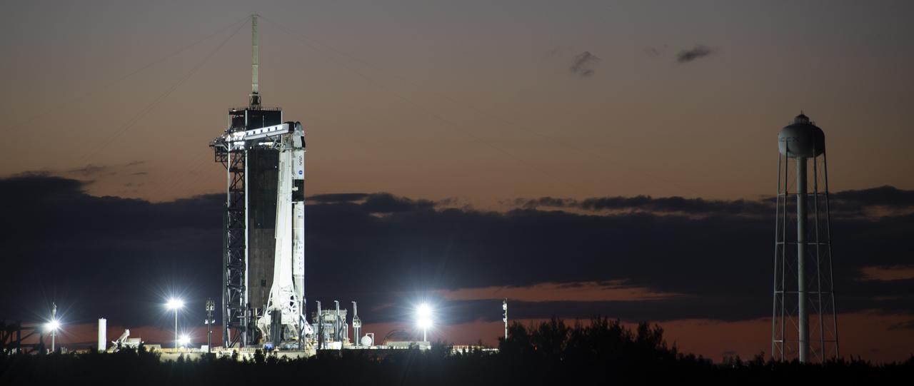 A SpaceX Falcon 9 rocket with the company's Crew Dragon spacecraft onboard is seen on the launch pad at Launch Complex 39A as preparations continue for the Crew-3 mission, Saturday, Oct. 30, 2021, at NASA’s Kennedy Space Center in Florida. NASA’s SpaceX Crew-3 mission is the third crew rotation mission of the SpaceX Crew Dragon spacecraft and Falcon 9 rocket to the International Space Station as part of the agency’s Commercial Crew Program. NASA astronauts Raja Chari, Tom Marshburn, Kayla Barron, and ESA (European Space Agency) astronaut Matthias Maurer are scheduled to launch on Nov. 3 at 1:10 a.m. ET, from Launch Complex 39A at the Kennedy Space Center. Photo Credit: (NASA/Joel Kowsky)
