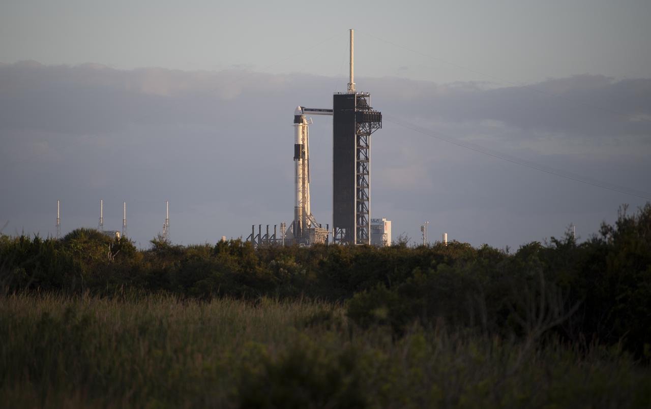 A SpaceX Falcon 9 rocket with the company's Crew Dragon spacecraft onboard is seen at sunset on the launch pad at Launch Complex 39A as preparations continue for the Crew-3 mission, Tuesday, Nov. 9, 2021, at NASA’s Kennedy Space Center in Florida. NASA’s SpaceX Crew-3 mission is the third crew rotation mission of the SpaceX Crew Dragon spacecraft and Falcon 9 rocket to the International Space Station as part of the agency’s Commercial Crew Program. NASA astronauts Raja Chari, Tom Marshburn, Kayla Barron, and ESA (European Space Agency) astronaut Matthias Maurer are scheduled to launch no earlier than Nov. 10 at 9:03 p.m. EST, from Launch Complex 39A at the Kennedy Space Center. Photo Credit: (NASA/Joel Kowsky)
