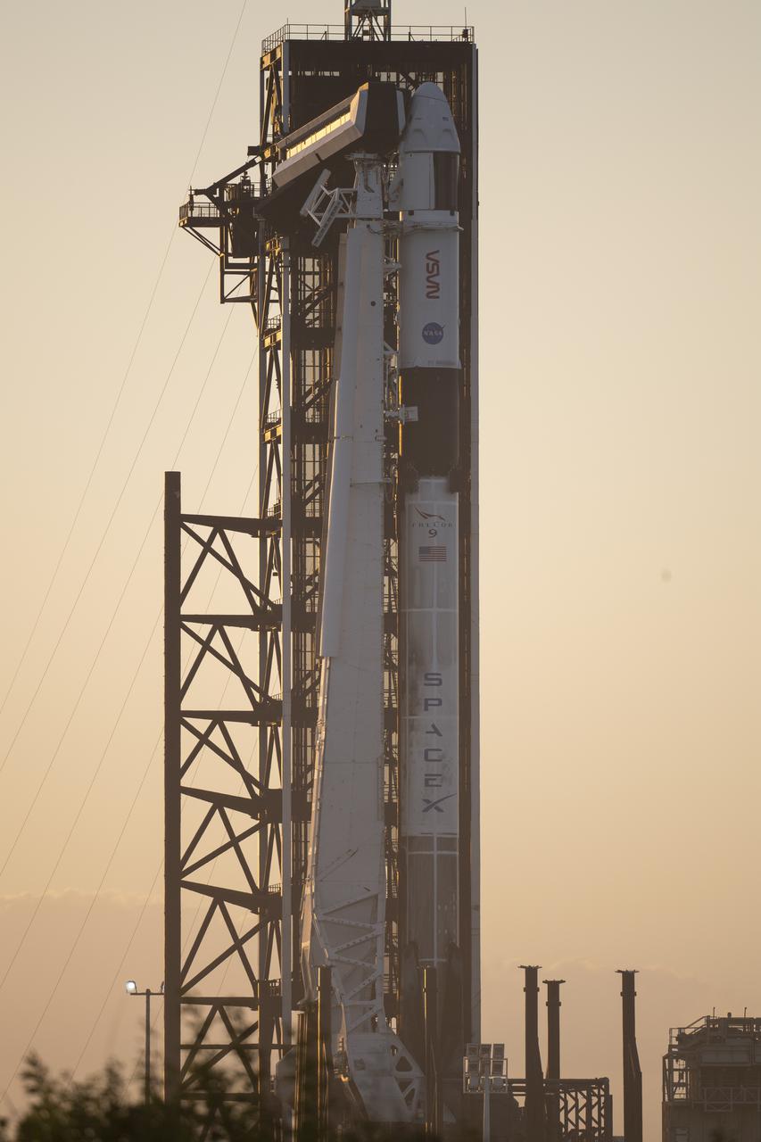 A SpaceX Falcon 9 rocket with the company's Crew Dragon spacecraft onboard is seen at sunset on the launch pad at Launch Complex 39A as preparations continue for the Crew-3 mission, Tuesday, Nov. 9, 2021, at NASA’s Kennedy Space Center in Florida. NASA’s SpaceX Crew-3 mission is the third crew rotation mission of the SpaceX Crew Dragon spacecraft and Falcon 9 rocket to the International Space Station as part of the agency’s Commercial Crew Program. NASA astronauts Raja Chari, Tom Marshburn, Kayla Barron, and ESA (European Space Agency) astronaut Matthias Maurer are scheduled to launch no earlier than Nov. 10 at 9:03 p.m. EST, from Launch Complex 39A at the Kennedy Space Center. Photo Credit: (NASA/Joel Kowsky)