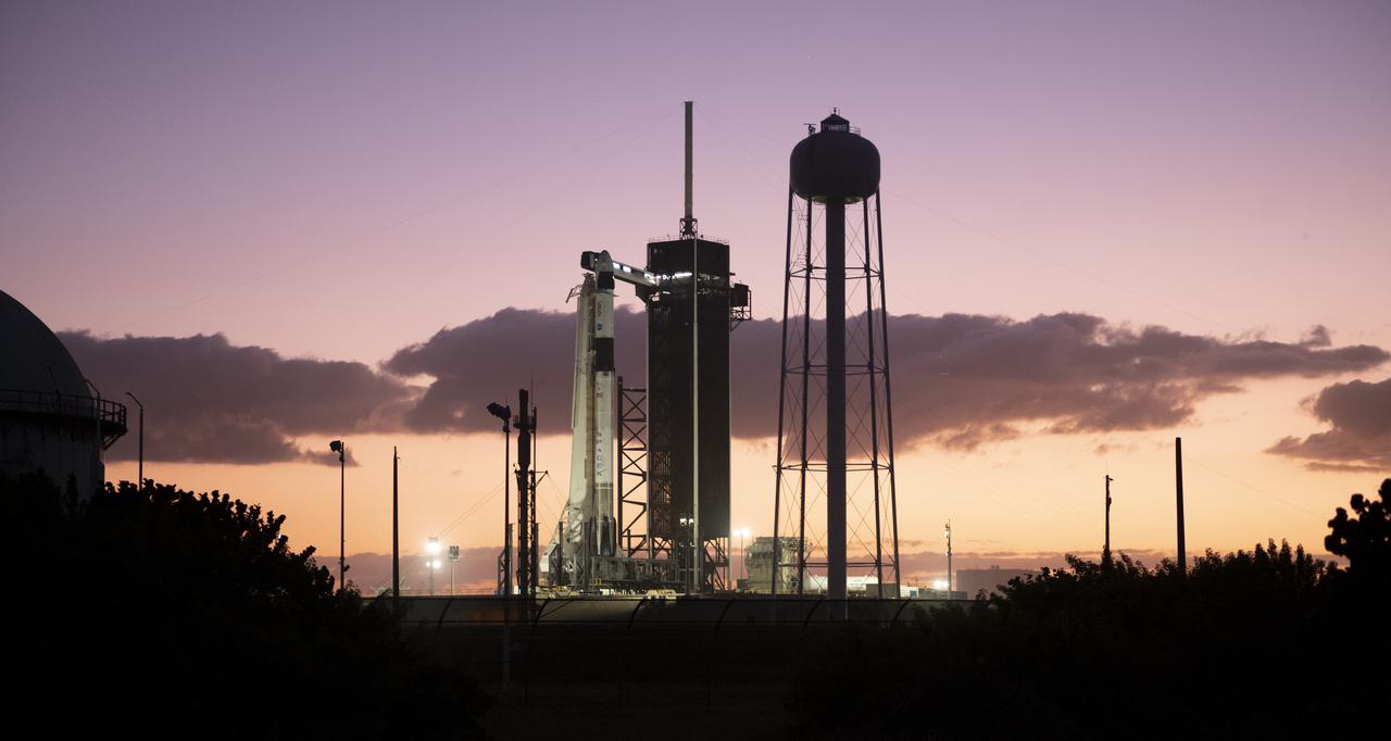 A SpaceX Falcon 9 rocket with the company's Crew Dragon spacecraft onboard is seen at sunset on the launch pad at Launch Complex 39A as preparations continue for the Crew-3 mission, Tuesday, Nov. 9, 2021, at NASA’s Kennedy Space Center in Florida. NASA’s SpaceX Crew-3 mission is the third crew rotation mission of the SpaceX Crew Dragon spacecraft and Falcon 9 rocket to the International Space Station as part of the agency’s Commercial Crew Program. NASA astronauts Raja Chari, Tom Marshburn, Kayla Barron, and ESA (European Space Agency) astronaut Matthias Maurer are scheduled to launch no earlier than Nov. 10 at 9:03 p.m. EST, from Launch Complex 39A at the Kennedy Space Center. Photo Credit: (NASA/Joel Kowsky)