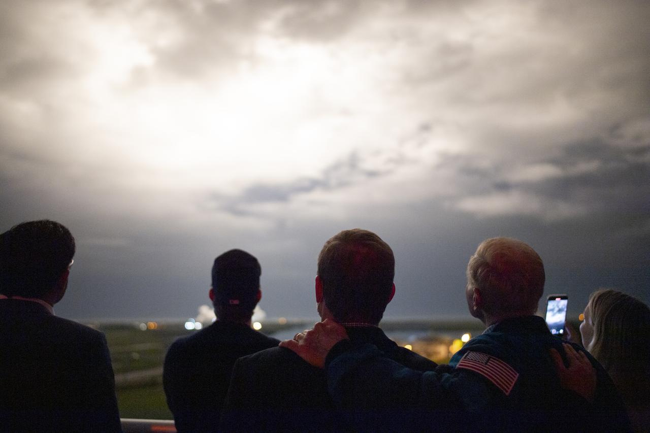 NASA Administrator Bill Nelson, right, and his son Bill Nelson Jr., left, watch the launch of a SpaceX Falcon 9 rocket carrying the company's Crew Dragon spacecraft on NASA’s SpaceX Crew-3 mission with NASA astronauts Raja Chari, Tom Marshburn, Kayla Barron, and ESA (European Space Agency) astronaut Matthias Maurer onboard, Wednesday, Nov. 10, 2021, from the balcony of Operations Support Building II at NASA’s Kennedy Space Center in Florida. NASA’s SpaceX Crew-3 mission is the third crew rotation mission of the SpaceX Crew Dragon spacecraft and Falcon 9 rocket to the International Space Station as part of the agency’s Commercial Crew Program. Chari, Marshburn, Barron, Maurer launched at 9:03 p.m. EST from Launch Complex 39A at the Kennedy Space Center to begin a six month mission onboard the orbital outpost. Photo Credit: (NASA/Joel Kowsky)