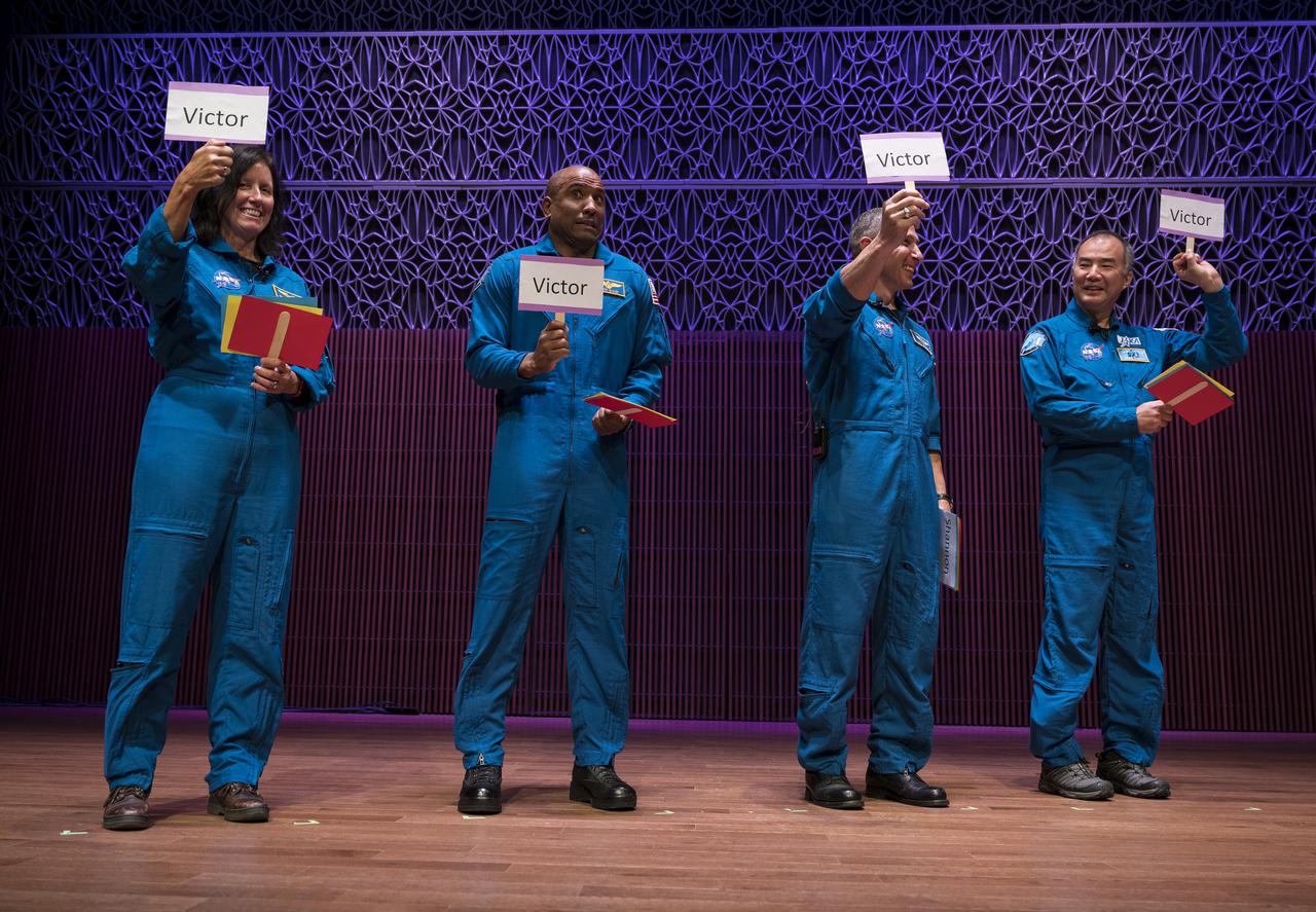 SpaceX Crew-1 NASA astronauts, from left to right, Shannon Walker, Victor Glover, Mike Hopkins, and Japan Aerospace Exploration Agency (JAXA) astronaut Soichi Noguchi, hold up cards in answer to an interview question in the Oprah Winfrey Theater at the National Museum of African American History and Culture, Tuesday, Nov. 16, 2021, in Washington. Hopkins, Glover, Walker, and Noguchi launched on the first crew rotation mission to the International Space Station for SpaceX’s Falcon 9 and Crew Dragon spacecraft as part of the agency’s Commercial Crew Program and spent 168 days in space across Expeditions 64 and 65. Photo Credit: (NASA/Aubrey Gemignani)