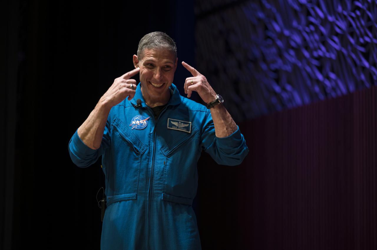 SpaceX Crew-1 NASA astronaut Mike Hopkins reacts during an interview in the Oprah Winfrey Theater at the National Museum of African American History and Culture, Tuesday, Nov. 16, 2021, in Washington. Hopkins, and crew mates NASA astronauts Shannon Walker and Victor Glover, and Japan Aerospace Exploration Agency (JAXA) astronaut Soichi Noguchi, right, launched on the first crew rotation mission to the International Space Station for SpaceX’s Falcon 9 and Crew Dragon spacecraft as part of the agency’s Commercial Crew Program and spent 168 days in space across Expeditions 64 and 65. Photo Credit: (NASA/Aubrey Gemignani)