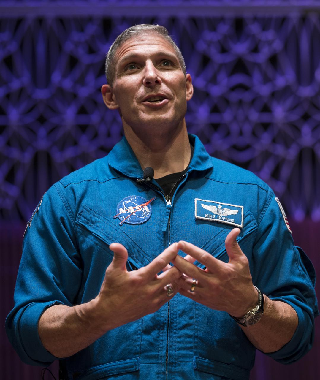 SpaceX Crew-1 NASA astronaut Mike Hopkins speaks during a presentation about his mission in the Oprah Winfrey Theater at the National Museum of African American History and Culture, Tuesday, Nov. 16, 2021, in Washington. Hopkins, and crew mates NASA astronauts Shannon Walker and Victor Glover, and Japan Aerospace Exploration Agency (JAXA) astronaut Soichi Noguchi, right, launched on the first crew rotation mission to the International Space Station for SpaceX’s Falcon 9 and Crew Dragon spacecraft as part of the agency’s Commercial Crew Program and spent 168 days in space across Expeditions 64 and 65. Photo Credit: (NASA/Aubrey Gemignani)