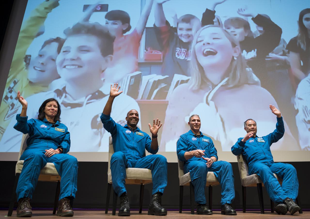 SpaceX Crew-1 NASA astronauts, from left to right, Shannon Walker, Victor Glover, Mike Hopkins, and Japan Aerospace Exploration Agency (JAXA) astronaut Soichi Noguchi, wave at students during a live question and answer session in the Oprah Winfrey Theater at the National Museum of African American History and Culture (NMAAHC), Tuesday, Nov. 16, 2021, in Washington. Hopkins, Glover, Walker, and Noguchi launched on the first crew rotation mission to the International Space Station for SpaceX’s Falcon 9 and Crew Dragon spacecraft as part of the agency’s Commercial Crew Program and spent 168 days in space across Expeditions 64 and 65. Photo Credit: (NASA/Aubrey Gemignani)