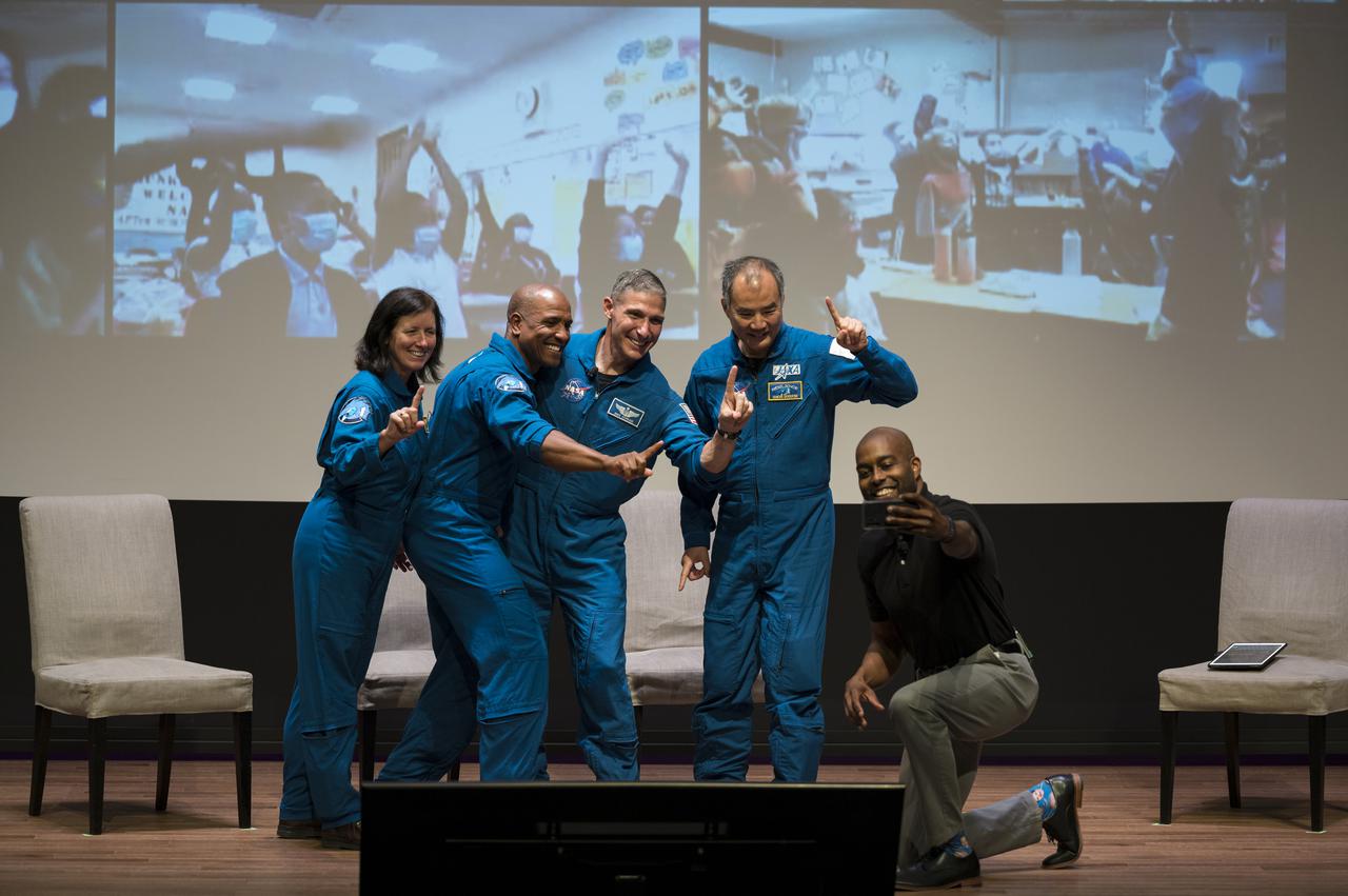 SpaceX Crew-1 NASA astronauts, from left to right, Shannon Walker, Victor Glover, Mike Hopkins, and Japan Aerospace Exploration Agency (JAXA) astronaut Soichi Noguchi, take a selfie with National Museum of African American History and Culture (NMAAHC) STEM educator Christopher Williams, after a live question and answer session in the Oprah Winfrey Theater at the NMAAHC, Tuesday, Nov. 16, 2021, in Washington. Hopkins, Glover, Walker, and Noguchi launched on the first crew rotation mission to the International Space Station for SpaceX’s Falcon 9 and Crew Dragon spacecraft as part of the agency’s Commercial Crew Program and spent 168 days in space across Expeditions 64 and 65. Photo Credit: (NASA/Aubrey Gemignani)