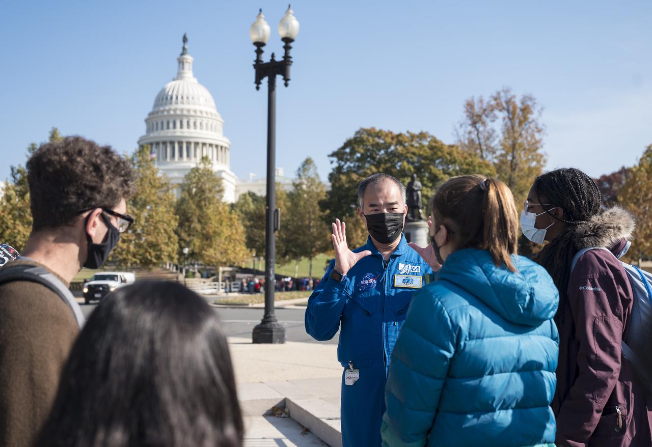 Japan Aerospace Exploration Agency (JAXA) astronaut Soichi Noguchi speaks with visitors at the Destination Station mobile exhibition on Capitol Hill, Wednesday, Nov. 17, 2021, in Washington. Noguchi and crew mates NASA astronauts Mike Hopkins, Victor Glover, and Shannon Walker, launched on the first crew rotation mission to the International Space Station for SpaceX’s Falcon 9 and Crew Dragon spacecraft as part of the agency’s Commercial Crew Program and spent 168 days in space across Expeditions 64 and 65. Photo Credit: (NASA/Aubrey Gemignani)