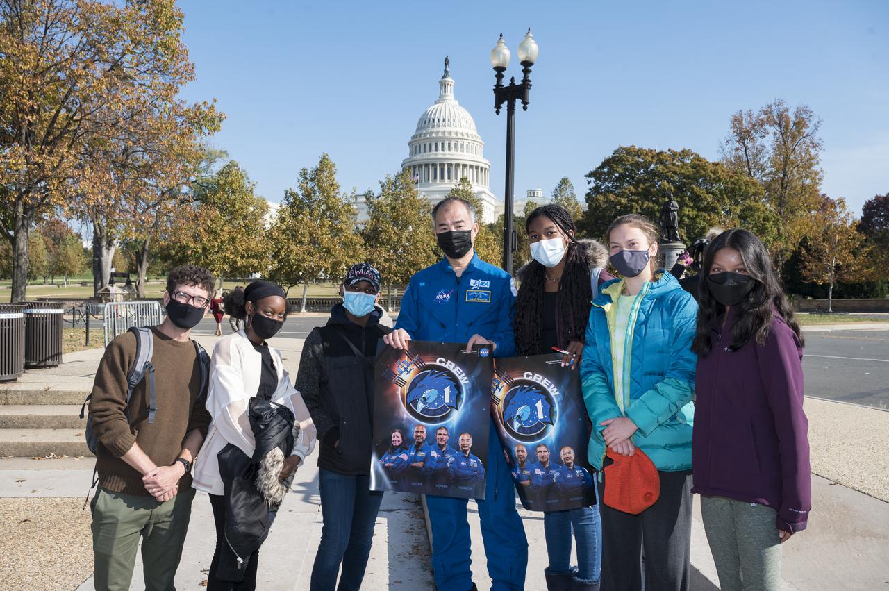 Japan Aerospace Exploration Agency (JAXA) astronaut Soichi Noguchi poses for a photo with visitors at the Destination Station mobile exhibition on Capitol Hill, Wednesday, Nov. 17, 2021, in Washington. Noguchi and crew mates NASA astronauts Mike Hopkins, Victor Glover, and Shannon Walker, launched on the first crew rotation mission to the International Space Station for SpaceX’s Falcon 9 and Crew Dragon spacecraft as part of the agency’s Commercial Crew Program and spent 168 days in space across Expeditions 64 and 65. Photo Credit: (NASA/Aubrey Gemignani)