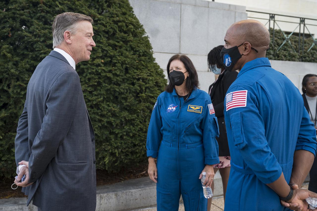 SpaceX Crew-1 NASA astronauts Shannon Walker, center, and Victor Glover, right, speak with Senator John Hickenlooper, D-Colo, at the Destination Station mobile exhibition on Capitol Hill, Wednesday, Nov. 17, 2021, in Washington. Walker, Glover, NASA astronaut Mike Hopkins, and Japan Aerospace Exploration Agency (JAXA) astronaut Soichi Noguchi launched on the first crew rotation mission to the International Space Station for SpaceX’s Falcon 9 and Crew Dragon spacecraft as part of the agency’s Commercial Crew Program and spent 168 days in space across Expeditions 64 and 65. Photo Credit: (NASA/Aubrey Gemignani)