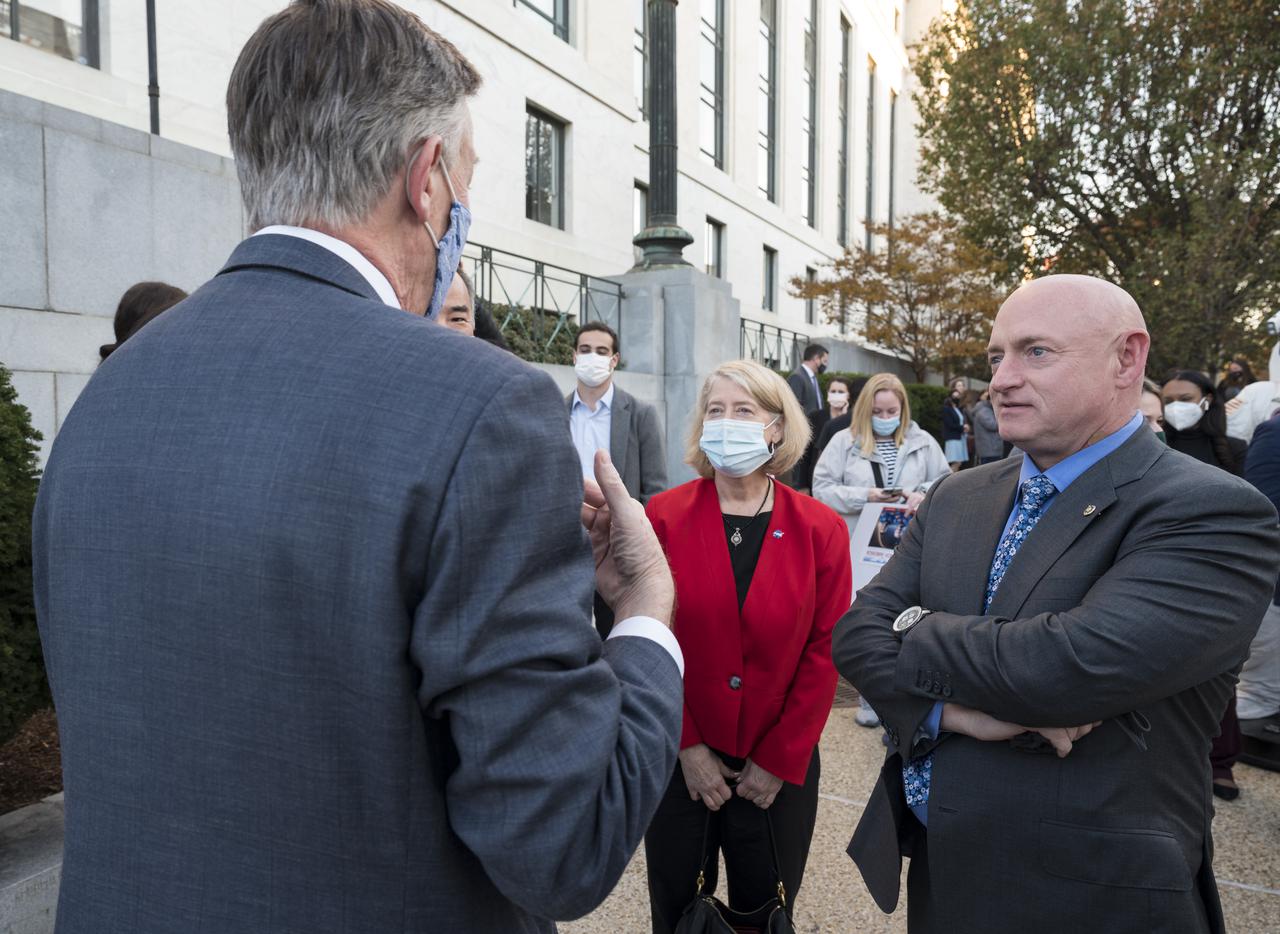 NASA Deputy Administrator Pam Melroy, center, and former astronaut and Senator Mark Kelly, D-Ariz., right, speak with Senator John Hickenlooper, D-Colo, at the Destination Station mobile exhibition on Capitol Hill, Wednesday, Nov. 17, 2021, in Washington. Photo Credit: (NASA/Aubrey Gemignani)