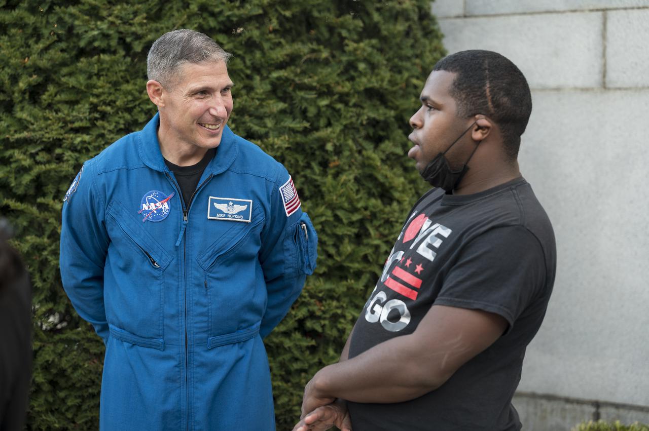 SpaceX Crew-1 NASA astronaut Mike Hopkins speaks with visitors at the Destination Station mobile exhibition on Capitol Hill, Wednesday, Nov. 17, 2021, in Washington. Hopkins and NASA astronauts Shannon Walker and Victor Glover, and Japan Aerospace Exploration Agency (JAXA) astronaut Soichi Noguchi launched on the first crew rotation mission to the International Space Station for SpaceX’s Falcon 9 and Crew Dragon spacecraft as part of the agency’s Commercial Crew Program and spent 168 days in space across Expeditions 64 and 65. Photo Credit: (NASA/Aubrey Gemignani)