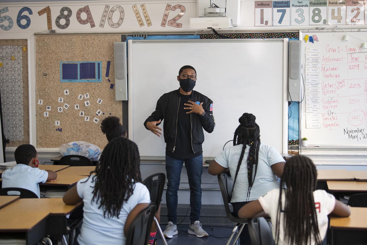 Kenneth Harris II, an engineer at NASA’s Goddard Space Flight Center, speaks with students about working in a clean room, Thursday, Nov. 18, 2021, at Garfield Elementary School in Washington, DC. Photo Credit: (NASA/Joel Kowsky)