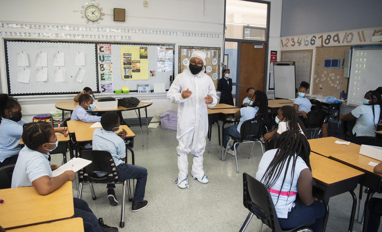 Kenneth Harris II, an engineer at NASA’s Goddard Space Flight Center, is seen in a “bunny suit” as he speaks with students about working in a clean room, Thursday, Nov. 18, 2021, at Garfield Elementary School in Washington, DC. Photo Credit: (NASA/Joel Kowsky)