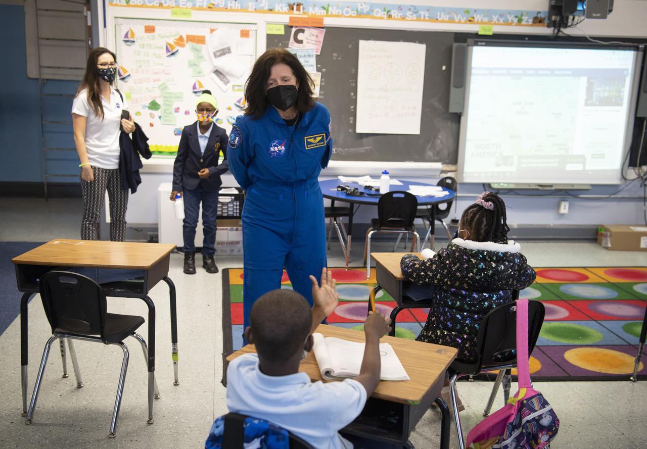 NASA astronaut Shannon Walker speaks with students about her time aboard the International Space Station during the Crew-1 mission, Thursday, Nov. 18, 2021, at Garfield Elementary School in Washington, DC. Walker and fellow NASA astronauts Victor Glover, Mike Hopkins, and Japan Aerospace Exploration Agency (JAXA) astronaut Soichi Noguchi launched on the first crew rotation mission to the International Space Station for SpaceX’s Falcon 9 and Crew Dragon spacecraft as part of the agency’s Commercial Crew Program and spent 168 days in space across Expeditions 64 and 65. Photo Credit: (NASA/Joel Kowsky)