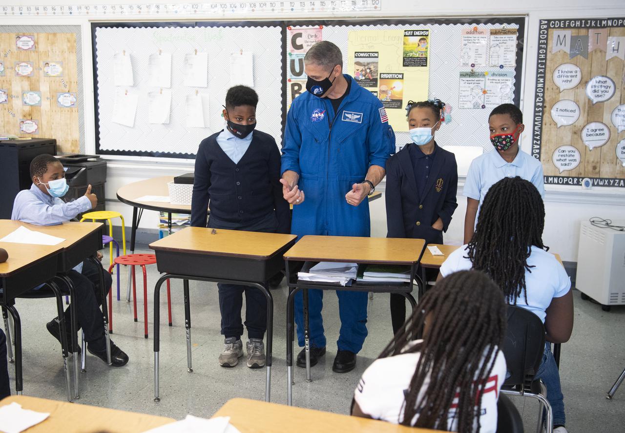 NASA astronaut Mike Hopkins speaks with students about his time aboard the International Space Station during the Crew-1 mission, Thursday, Nov. 18, 2021, at Garfield Elementary School in Washington, DC. Hopkins and fellow NASA astronauts Shannon Walker, Victor Glover, and Japan Aerospace Exploration Agency (JAXA) astronaut Soichi Noguchi launched on the first crew rotation mission to the International Space Station for SpaceX’s Falcon 9 and Crew Dragon spacecraft as part of the agency’s Commercial Crew Program and spent 168 days in space across Expeditions 64 and 65. Photo Credit: (NASA/Joel Kowsky)