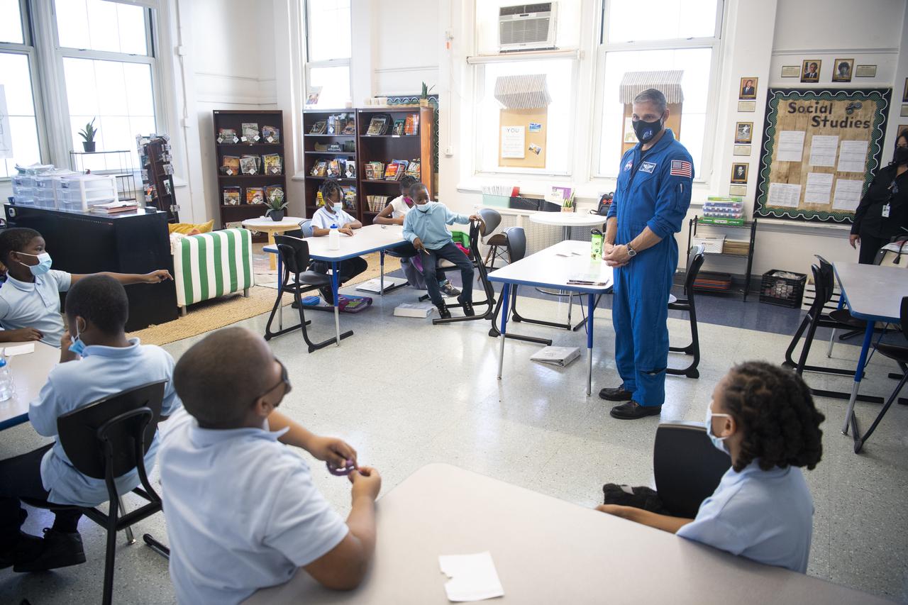 NASA astronaut Mike Hopkins speaks with students about his time aboard the International Space Station during the Crew-1 mission, Thursday, Nov. 18, 2021, at Garfield Elementary School in Washington, DC. Hopkins and fellow NASA astronauts Shannon Walker, Victor Glover, and Japan Aerospace Exploration Agency (JAXA) astronaut Soichi Noguchi launched on the first crew rotation mission to the International Space Station for SpaceX’s Falcon 9 and Crew Dragon spacecraft as part of the agency’s Commercial Crew Program and spent 168 days in space across Expeditions 64 and 65. Photo Credit: (NASA/Joel Kowsky)