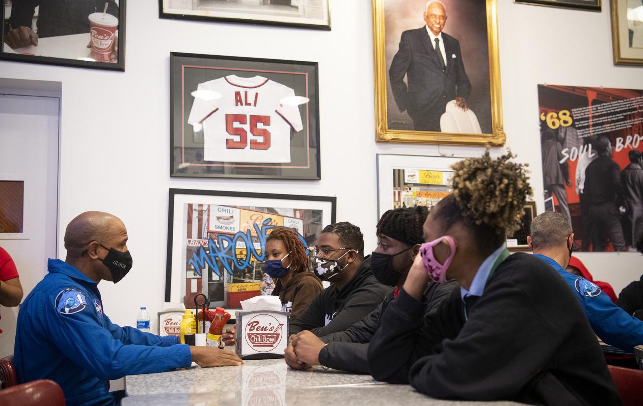 NASA astronaut Victor Glover speaks with students about his time aboard the International Space Station, Thursday, Nov. 18, 2021, at Ben’s Chili Bowl in Washington, DC. Students from Cardozo Educational Campus, Friendship Technology Preparatory High School, McKinley Technical High School, Phelps High School, and Wilson High School heard NASA astronauts Glover, Mike Hopkins, and Shannon Walker speak about the Crew-1 mission, the first crew rotation mission to the International Space Station for SpaceX’s Falcon 9 and Crew Dragon spacecraft as part of the agency’s Commercial Crew Program and the 168 days they spent in space across Expeditions 64 and 65. Photo Credit: (NASA/Joel Kowsky)