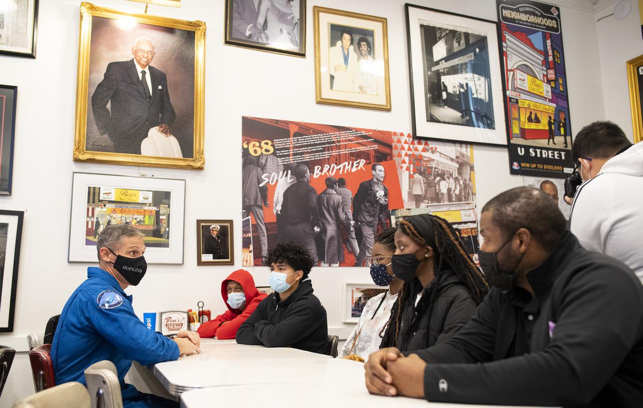 NASA astronaut Mike Hopkins speaks with students about his time aboard the International Space Station, Thursday, Nov. 18, 2021, at Ben’s Chili Bowl in Washington, DC. Students from Cardozo Educational Campus, Friendship Technology Preparatory High School, McKinley Technical High School, Phelps High School, and Wilson High School heard NASA astronauts Hopkins, Victor Glover, and Shannon Walker speak about the Crew-1 mission, the first crew rotation mission to the International Space Station for SpaceX’s Falcon 9 and Crew Dragon spacecraft as part of the agency’s Commercial Crew Program and the 168 days they spent in space across Expeditions 64 and 65. Photo Credit: (NASA/Joel Kowsky)