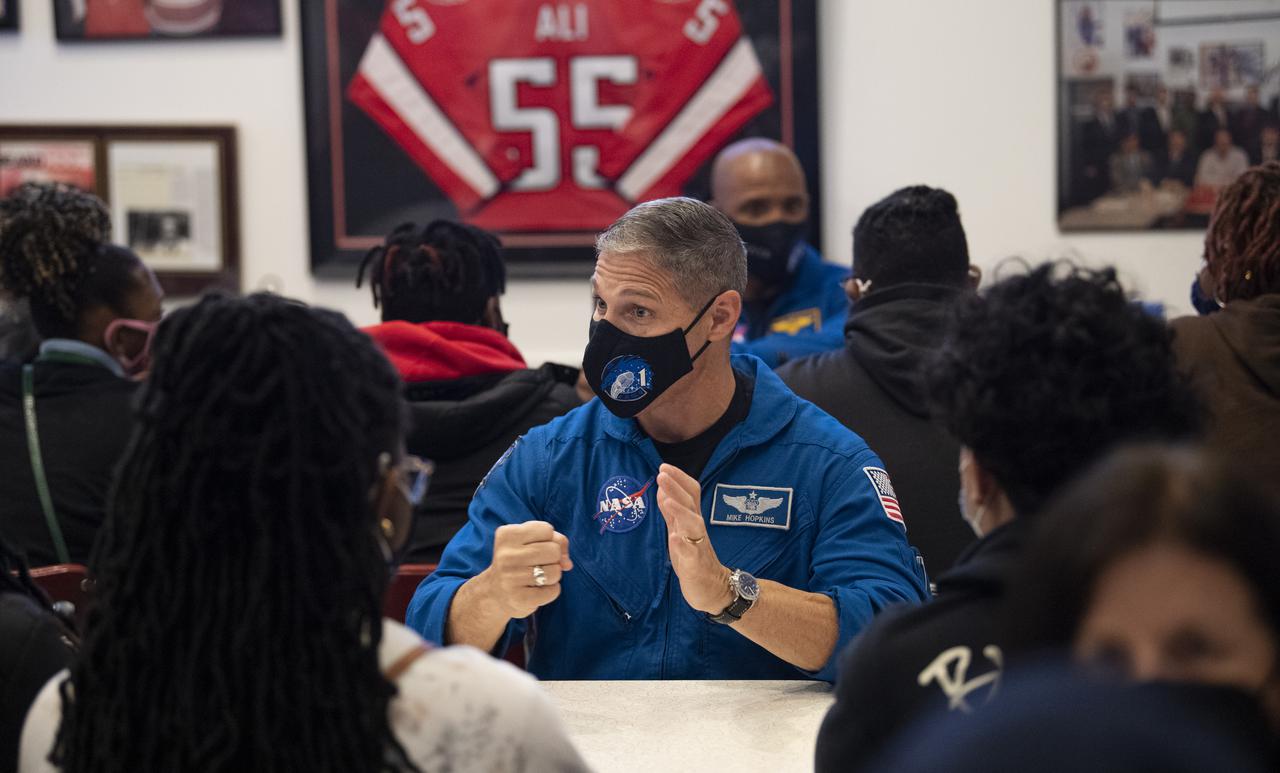 NASA astronaut Mike Hopkins speaks with students about his time aboard the International Space Station, Thursday, Nov. 18, 2021, at Ben’s Chili Bowl in Washington, DC. Students from Cardozo Educational Campus, Friendship Technology Preparatory High School, McKinley Technical High School, Phelps High School, and Wilson High School heard NASA astronauts Hopkins, Victor Glover, and Shannon Walker speak about the Crew-1 mission, the first crew rotation mission to the International Space Station for SpaceX’s Falcon 9 and Crew Dragon spacecraft as part of the agency’s Commercial Crew Program and the 168 days they spent in space across Expeditions 64 and 65. Photo Credit: (NASA/Joel Kowsky)