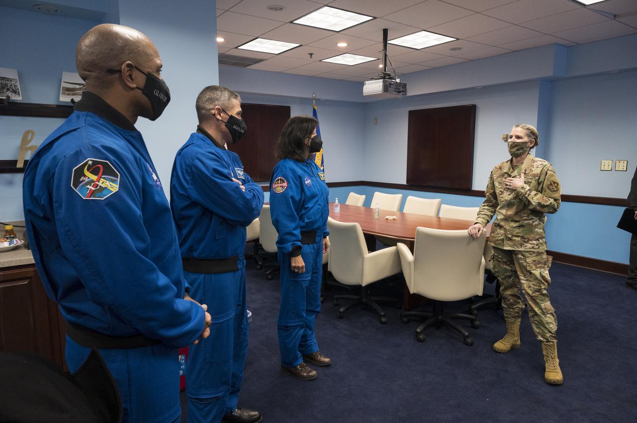 SpaceX Crew-1 NASA astronauts, from left, Victor Glover, Mike Hopkins, and Shannon Walker, meet with Col. Catherine Logan, commander of Joint Base Anacostia-Bolling (JBAB), Friday, Nov. 19, 2021, in Washington. Hopkins, Glover, Walker, and Japan Aerospace Exploration Agency (JAXA) astronaut Soichi Noguchi, launched on the first crew rotation mission to the International Space Station for SpaceX’s Falcon 9 and Crew Dragon spacecraft as part of the agency’s Commercial Crew Program and spent 168 days in space across Expeditions 64 and 65. Photo Credit: (NASA/Aubrey Gemignani)