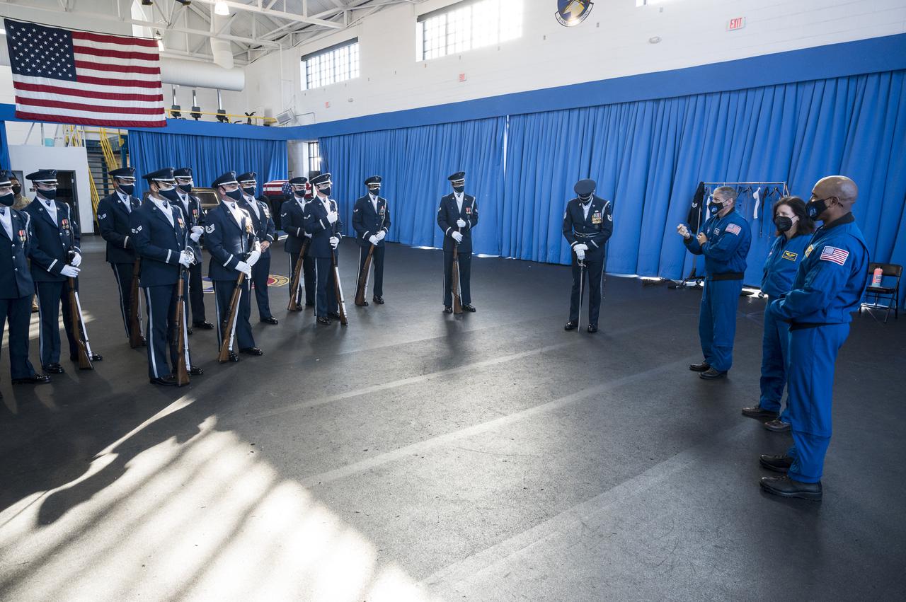 SpaceX Crew-1 NASA astronauts Mike Hopkins, third from right, Shannon Walker, second from right, and Victor Glover speak with the U.S. Air Force Honor Guard Drill Team at Joint Base Anacostia-Bolling (JBAB), Friday, Nov. 19, 2021, in Washington. Hopkins, Glover, Walker, and Japan Aerospace Exploration Agency (JAXA) astronaut Soichi Noguchi, launched on the first crew rotation mission to the International Space Station for SpaceX’s Falcon 9 and Crew Dragon spacecraft as part of the agency’s Commercial Crew Program and spent 168 days in space across Expeditions 64 and 65. Photo Credit: (NASA/Aubrey Gemignani)