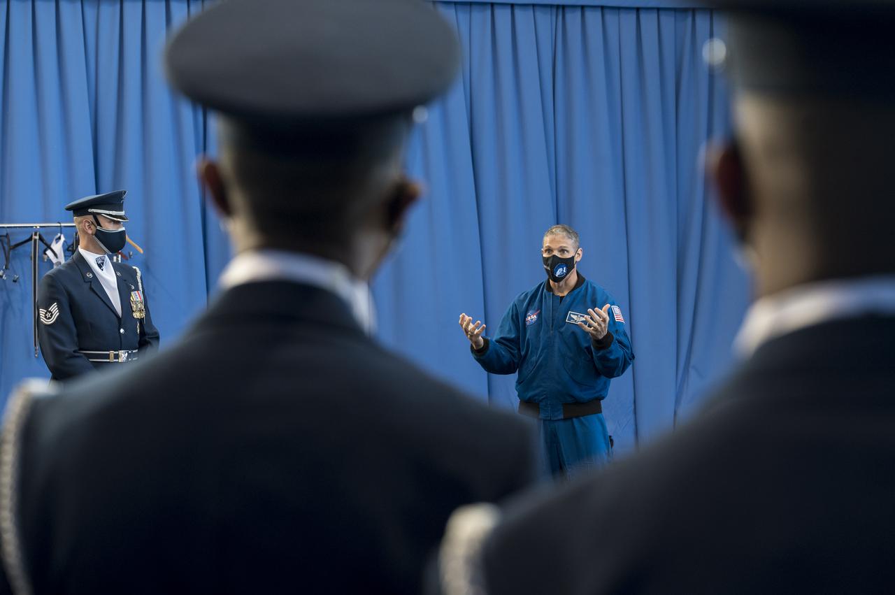 SpaceX Crew-1 NASA astronaut Mike Hopkins speaks with the U.S. Air Force Honor Guard Drill Team at Joint Base Anacostia-Bolling (JBAB), Friday, Nov. 19, 2021, in Washington. Hopkins, and crew mates NASA Astronauts Victor Glover, Shannon Walker, and Japan Aerospace Exploration Agency (JAXA) astronaut Soichi Noguchi, launched on the first crew rotation mission to the International Space Station for SpaceX’s Falcon 9 and Crew Dragon spacecraft as part of the agency’s Commercial Crew Program and spent 168 days in space across Expeditions 64 and 65. Photo Credit: (NASA/Aubrey Gemignani)