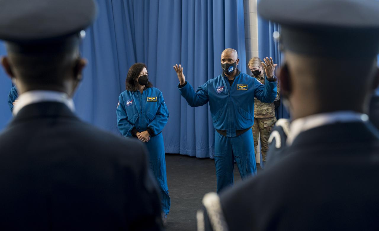 SpaceX Crew-1 NASA astronauts Shannon Walker, left, and Victor Glover, right, speak with the U.S. Air Force Honor Guard Drill Team at Joint Base Anacostia-Bolling (JBAB), Friday, Nov. 19, 2021, in Washington. Walker, Glover, and crew mates NASA astronaut Mike Hopkins, and Japan Aerospace Exploration Agency (JAXA) astronaut Soichi Noguchi, launched on the first crew rotation mission to the International Space Station for SpaceX’s Falcon 9 and Crew Dragon spacecraft as part of the agency’s Commercial Crew Program and spent 168 days in space across Expeditions 64 and 65. Photo Credit: (NASA/Aubrey Gemignani)