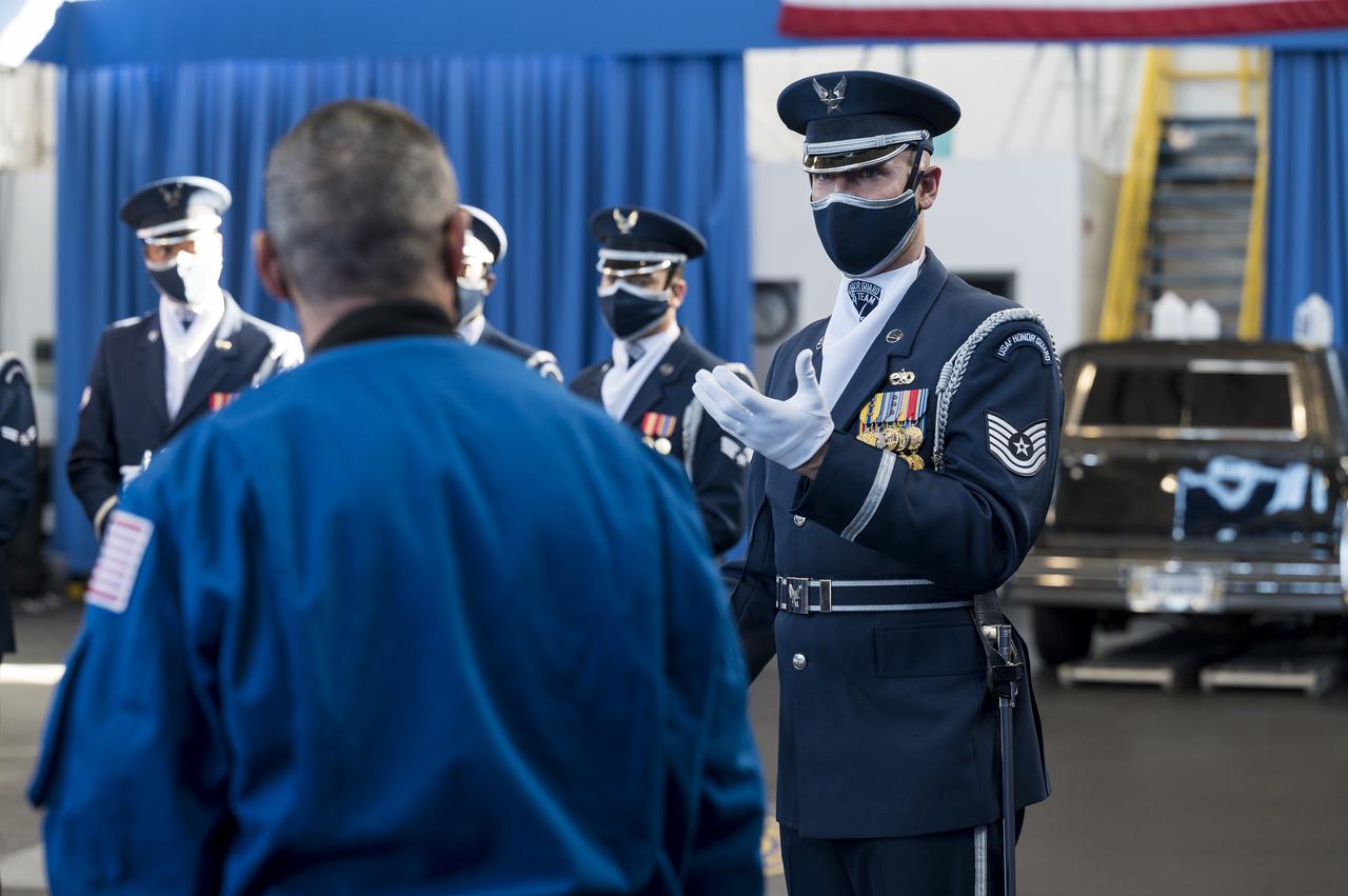 SpaceX Crew-1 NASA astronaut Mike Hopkins speaks with the U.S. Air Force Honor Guard Drill Team at Joint Base Anacostia-Bolling (JBAB), Friday, Nov. 19, 2021, in Washington. Hopkins, and crew mates NASA Astronauts Victor Glover, Shannon Walker, and Japan Aerospace Exploration Agency (JAXA) astronaut Soichi Noguchi, launched on the first crew rotation mission to the International Space Station for SpaceX’s Falcon 9 and Crew Dragon spacecraft as part of the agency’s Commercial Crew Program and spent 168 days in space across Expeditions 64 and 65. Photo Credit: (NASA/Aubrey Gemignani)