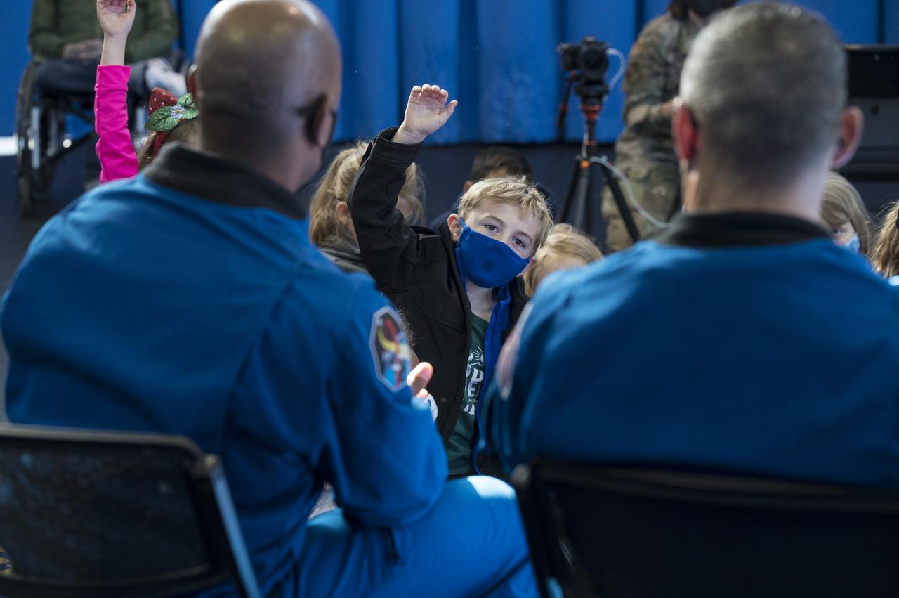 SpaceX Crew-1 NASA astronauts, Victor Glover, left, and Mike Hopkins, right, answer questions by students from the Learn DC public charter school at Joint Base Anacostia-Bolling (JBAB), Friday, Nov. 19, 2021, in Washington. Hopkins, Glover, NASA astronaut Shannon Walker, and Japan Aerospace Exploration Agency (JAXA) astronaut Soichi Noguchi, launched on the first crew rotation mission to the International Space Station for SpaceX’s Falcon 9 and Crew Dragon spacecraft as part of the agency’s Commercial Crew Program and spent 168 days in space across Expeditions 64 and 65. Photo Credit: (NASA/Aubrey Gemignani)