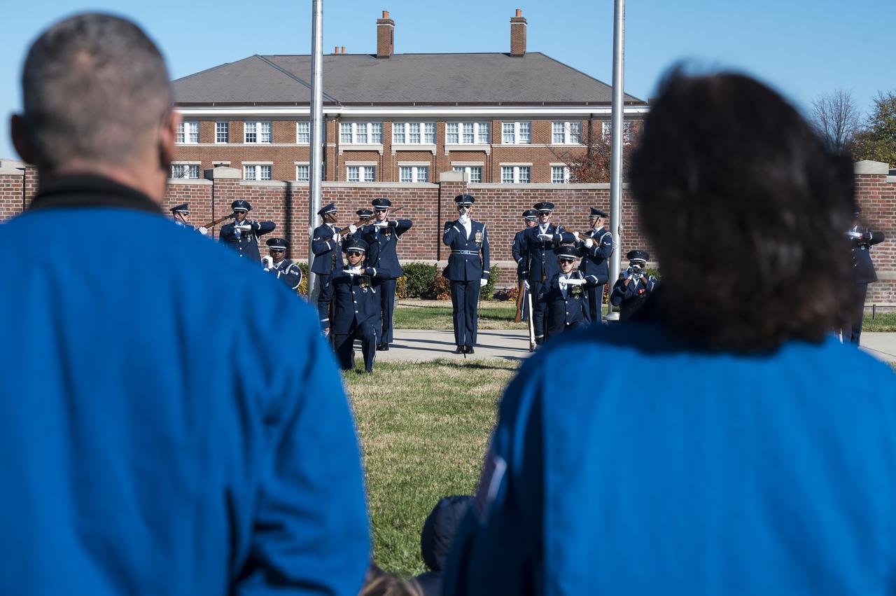 SpaceX Crew-1 NASA astronauts Mike Hopkins, left, and Shannon Walker watch the U.S. Air Force Honor Guard Drill Team perform at Joint Base Anacostia-Bolling (JBAB), Friday, Nov. 19, 2021, in Washington. Hopkins, Walker, NASA astronaut Victor Glover, and Japan Aerospace Exploration Agency (JAXA) astronaut Soichi Noguchi, launched on the first crew rotation mission to the International Space Station for SpaceX’s Falcon 9 and Crew Dragon spacecraft as part of the agency’s Commercial Crew Program and spent 168 days in space across Expeditions 64 and 65. Photo Credit: (NASA/Aubrey Gemignani)
