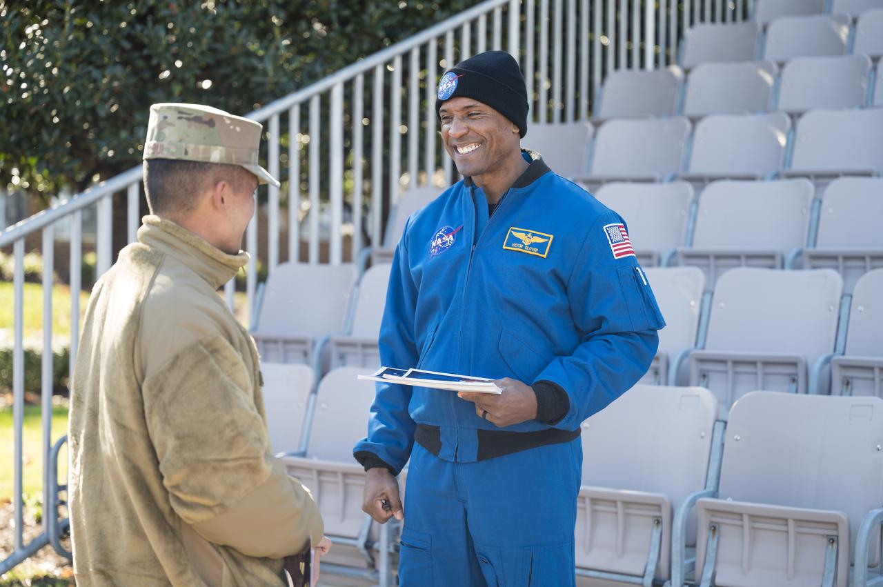 SpaceX Crew-1 NASA astronaut Victor Glover speaks with a Junior Officer at Joint Base Anacostia-Bolling (JBAB), Friday, Nov. 19, 2021, in Washington. Glover, and crew mates NASA astronauts Mike Hopkins, Shannon Walker, and Japan Aerospace Exploration Agency (JAXA) astronaut Soichi Noguchi, launched on the first crew rotation mission to the International Space Station for SpaceX’s Falcon 9 and Crew Dragon spacecraft as part of the agency’s Commercial Crew Program and spent 168 days in space across Expeditions 64 and 65. Photo Credit: (NASA/Aubrey Gemignani)
