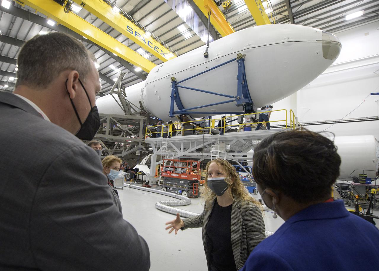 NASA Associate Administrator for the Science Mission Directorate Thomas Zurbuchen, left, and other NASA leadership listen as Julianna Scheiman, director for civil satellite missions at SpaceX, center, gives a tour of the hanger where the Falcon 9 rocket and DART spacecraft are being readied for launch, Monday, Nov. 22, 2021, at Vandenberg Space Force Base in California. DART is the world’s first full-scale planetary defense test, demonstrating one method of asteroid deflection technology. The mission was built and is managed by Johns Hopkins APL for NASA’s Planetary Defense Coordination Office. Photo Credit: (NASA/Bill Ingalls)