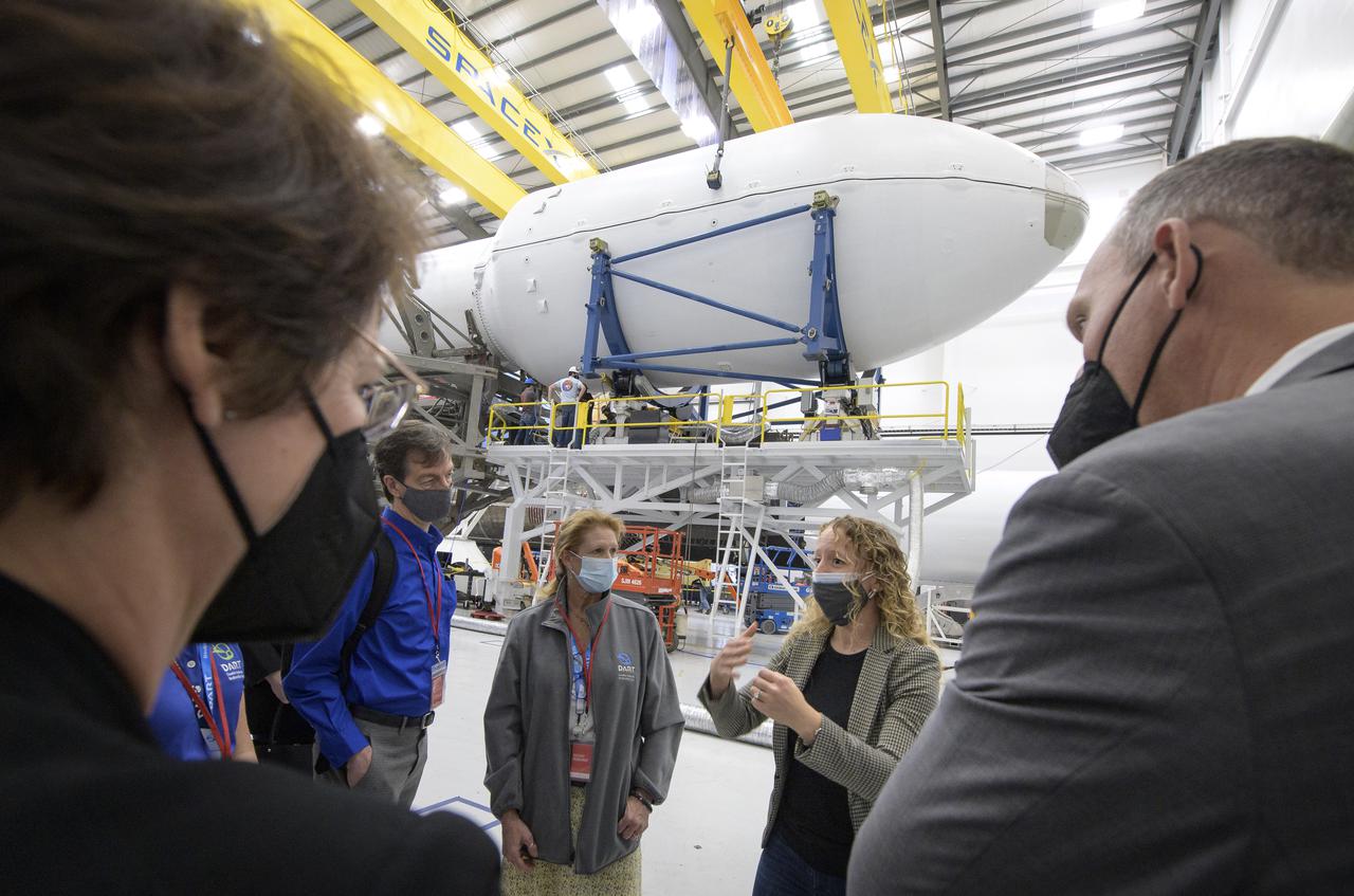 NASA Associate Administrator for the Science Mission Directorate Thomas Zurbuchen, right, and other NASA leadership listen as Julianna Scheiman, director for civil satellite missions, SpaceX, center, gives a tour of the hanger where the Falcon 9 rocket and DART spacecraft are being readied for launch, Monday, Nov. 22, 2021, at Vandenberg Space Force Base in California. DART is the world’s first full-scale planetary defense test, demonstrating one method of asteroid deflection technology. The mission was built and is managed by the Johns Hopkins APL for NASA’s Planetary Defense Coordination Office. Photo Credit: (NASA/Bill Ingalls)