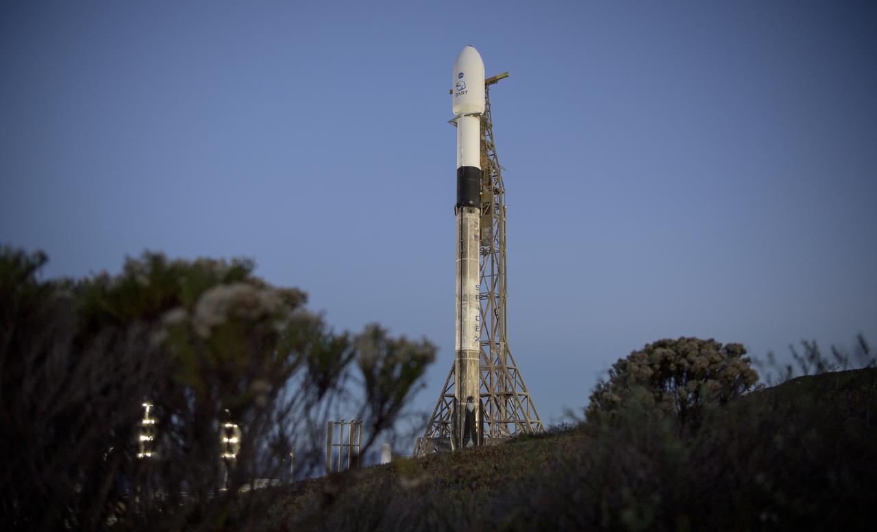 The SpaceX Falcon 9 rocket with the Double Asteroid Redirection Test, or DART, spacecraft onboard, is seen during sunrise, Tuesday, Nov. 23, 2021, at Space Launch Complex 4E, Vandenberg Space Force Base in California. DART is the world’s first full-scale planetary defense test, demonstrating one method of asteroid deflection technology. The mission was built and is managed by the Johns Hopkins APL for NASA’s Planetary Defense Coordination Office. Photo Credit: (NASA/Bill Ingalls)