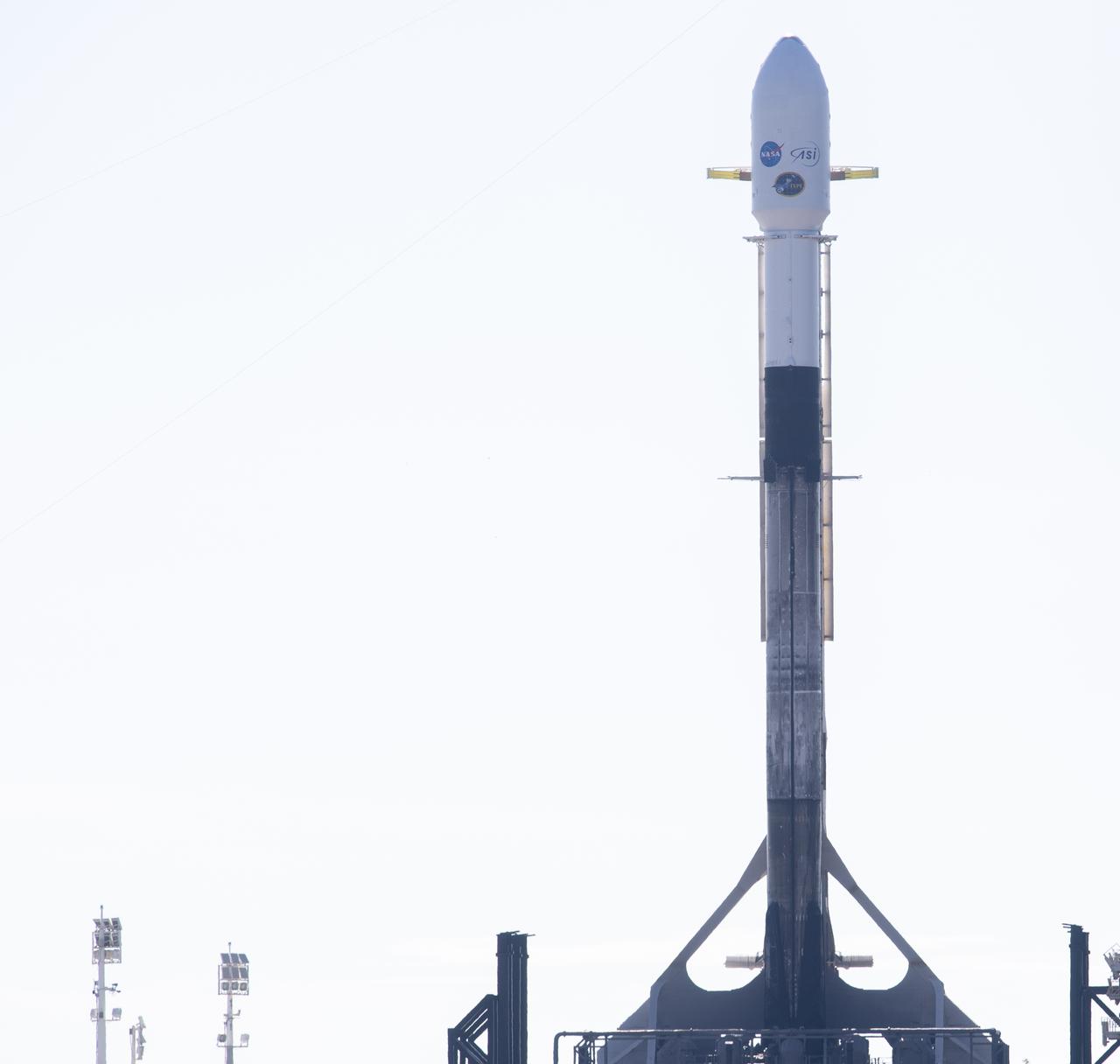 A SpaceX Falcon 9 rocket carrying NASA’s Imaging X-ray Polarimetry Explorer (IXPE) spacecraft is seen on the launch pad at Launch Complex 39A, Wednesday, Dec. 8, 2021, at NASA’s Kennedy Space Center in Florida. The IXPE spacecraft is the first satellite dedicated to measuring the polarization of X-rays from a variety of cosmic sources, such as black holes and neutron stars. Photo Credit: (NASA/Joel Kowsky)