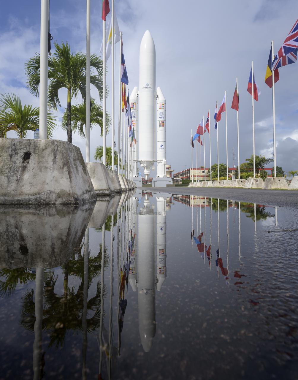 A mockup of Arianespace's Ariane 5 rocket is seen at the entrance to the Guiana Space Center in Kourou, French Guiana, Tuesday, Dec. 21, 2021. The James Webb Space Telescope (sometimes called JWST or Webb) is a large infrared telescope with a 21.3 foot (6.5 meter) primary mirror. The observatory is scheduled to launch later in the week and will study every phase of cosmic history—from within our solar system to the most distant observable galaxies in the early universe. Photo Credit: (NASA/Bill Ingalls)