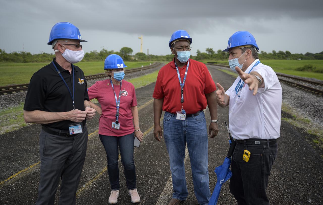 NASA James Webb Space Telescope Program Scientist Eric Smith left, NASA James Webb Space Telescope Program Manager Jeanne Davis, NASA Program Director for the James Webb Space Telescope Greg Robinson, and Arianespace’s Vice President for French Guiana Bruno Gérard, right, talk as they wait for Arianespace's Ariane 5 rocket with NASA’s James Webb Space Telescope onboard, to rollout to the launch pad, Thursday, Dec. 23, 2021, at Europe’s Spaceport, the Guiana Space Center in Kourou, French Guiana. The James Webb Space Telescope (sometimes called JWST or Webb) is a large infrared telescope with a 21.3 foot (6.5 meter) primary mirror. The observatory will study every phase of cosmic history—from within our solar system to the most distant observable galaxies in the early universe. Photo Credit: (NASA/Bill Ingalls)