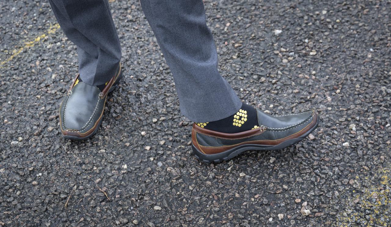 NASA James Webb Space Telescope Program Scientist Eric Smith, wearing Webb themed socks, waits for Arianespace's Ariane 5 rocket with NASA’s James Webb Space Telescope onboard, to rollout to the launch pad, Thursday, Dec. 23, 2021, at Europe’s Spaceport, the Guiana Space Center in Kourou, French Guiana. The James Webb Space Telescope (sometimes called JWST or Webb) is a large infrared telescope with a 21.3 foot (6.5 meter) primary mirror. The observatory will study every phase of cosmic history—from within our solar system to the most distant observable galaxies in the early universe. Photo Credit: (NASA/Bill Ingalls)