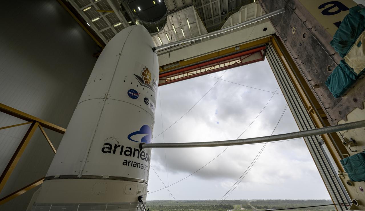 Arianespace's Ariane 5 rocket with NASA’s James Webb Space Telescope onboard, is seen ahead of rollout to the launch pad, Thursday, Dec. 23, 2021, at Europe’s Spaceport, the Guiana Space Center in Kourou, French Guiana. The James Webb Space Telescope (sometimes called JWST or Webb) is a large infrared telescope with a 21.3 foot (6.5 meter) primary mirror. The observatory will study every phase of cosmic history—from within our solar system to the most distant observable galaxies in the early universe. Photo Credit: (NASA/Bill Ingalls)