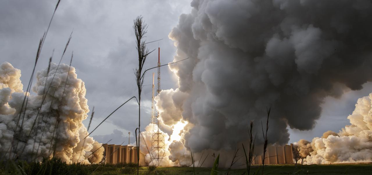 Steam and smoke from Arianespace's Ariane 5 Vulcain engine, center, and two solid rocket boosters, is seen as it launches with NASA’s James Webb Space Telescope onboard, Saturday, Dec. 25, 2021, from the ELA-3 Launch Zone of Europe’s Spaceport at the Guiana Space Centre in Kourou, French Guiana. The James Webb Space Telescope (sometimes called JWST or Webb) is a large infrared telescope with a 21.3 foot (6.5 meter) primary mirror. The observatory will study every phase of cosmic history—from within our solar system to the most distant observable galaxies in the early universe. Photo Credit: (NASA/Bill Ingalls)