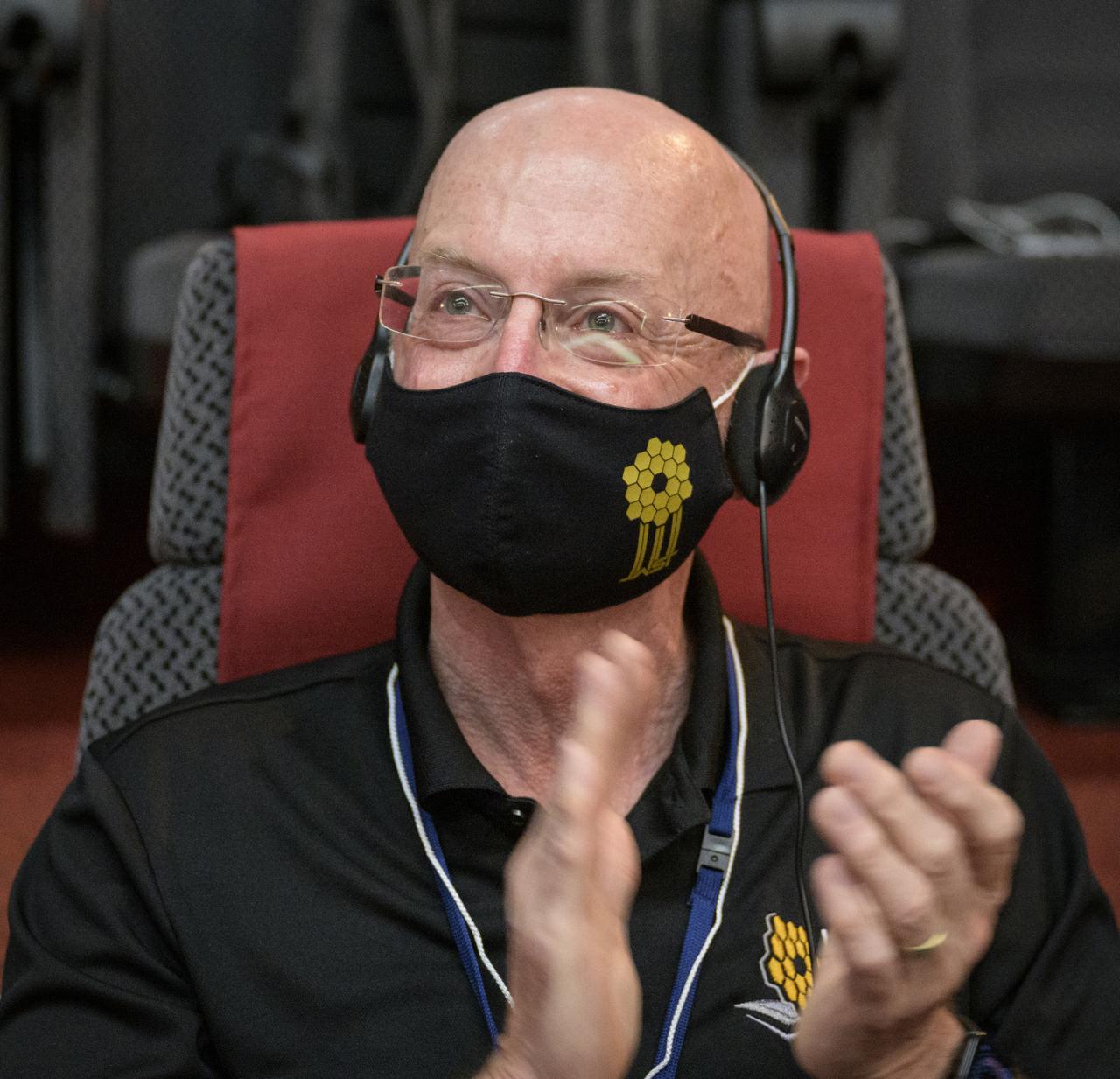 NASA James Webb Space Telescope Program Scientist Eric Smith reacts after hearing confirmation that the James Webb Space Telescope successfully separated from the Ariane 5 rocket, Saturday, Dec. 25, 2021, in the Jupiter Hall of the Guiana Space Centre in Kourou, French Guiana. The James Webb Space Telescope (sometimes called JWST or Webb) is a large infrared telescope with a 21.3 foot (6.5 meter) primary mirror. The observatory will study every phase of cosmic history—from within our solar system to the most distant observable galaxies in the early universe. Photo Credit: (NASA/Bill Ingalls)