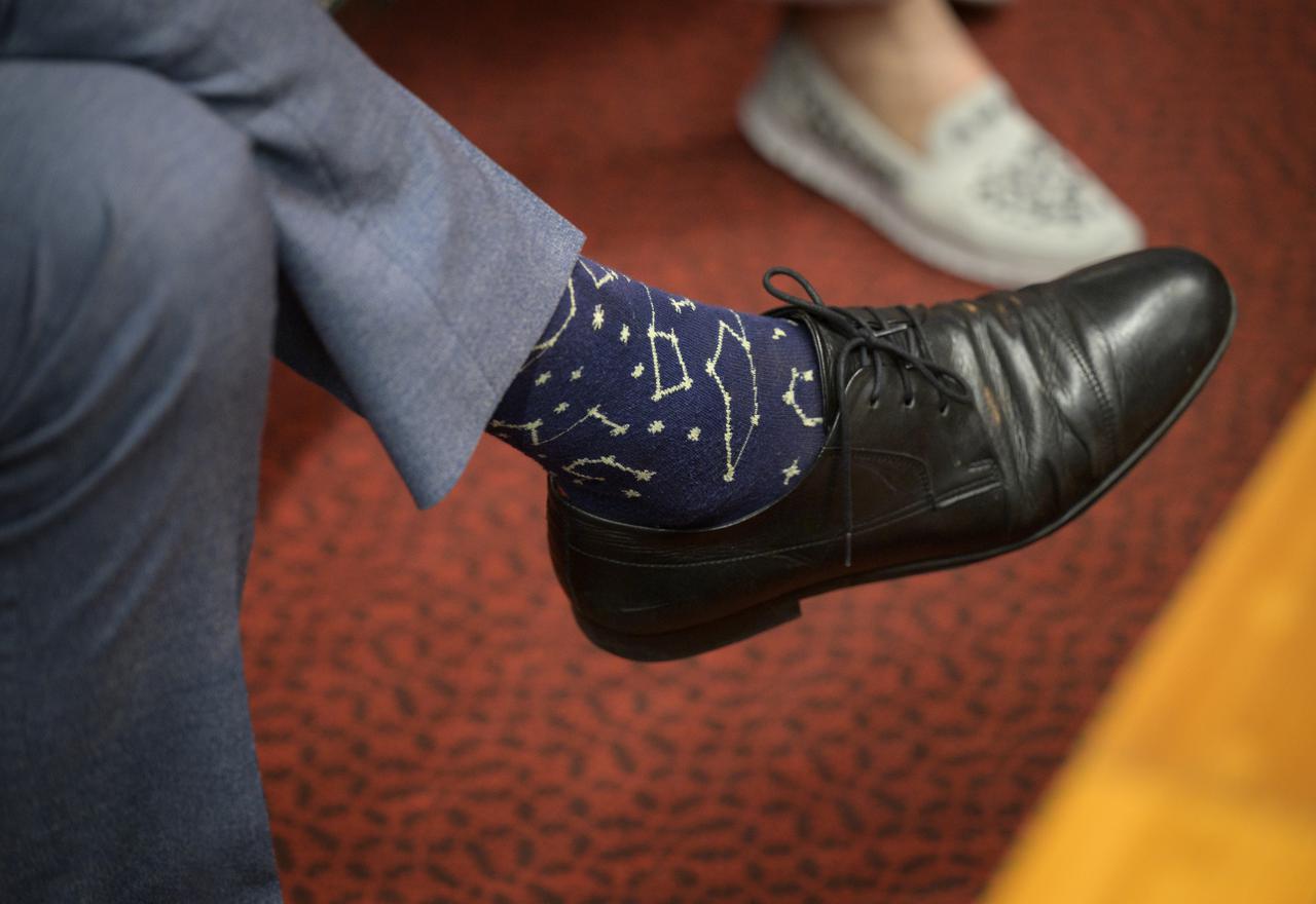 NASA Associate Administrator for the Science Mission Directorate Thomas Zurbuchen, wearing astrological themed socks, monitors the countdown to the launch of Arianespace's Ariane 5 rocket carrying NASA’s James Webb Space Telescope, Saturday, Dec. 25, 2021, in the Jupiter Center at the Guiana Space Center in Kourou, French Guiana. The James Webb Space Telescope (sometimes called JWST or Webb) is a large infrared telescope with a 21.3 foot (6.5 meter) primary mirror. The observatory will study every phase of cosmic history—from within our solar system to the most distant observable galaxies in the early universe. Photo Credit: (NASA/Bill Ingalls)