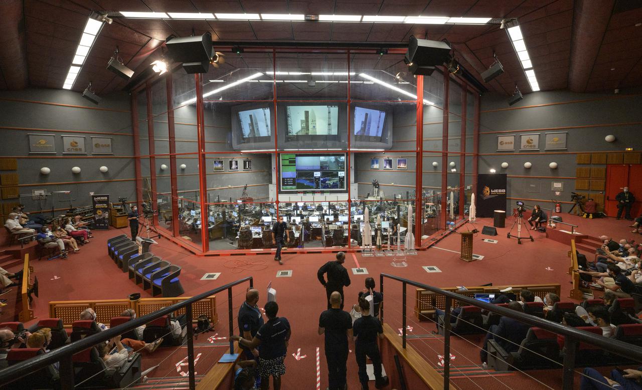 Launch teams monitor the countdown of the launch of Arianespace's Ariane 5 rocket carrying NASA’s James Webb Space Telescope, Saturday, Dec. 25, 2021, in the Jupiter Center at the Guiana Space Center in Kourou, French Guiana. The James Webb Space Telescope (sometimes called JWST or Webb) is a large infrared telescope with a 21.3 foot (6.5 meter) primary mirror. The observatory will study every phase of cosmic history—from within our solar system to the most distant observable galaxies in the early universe. Photo Credit: (NASA/Bill Ingalls)